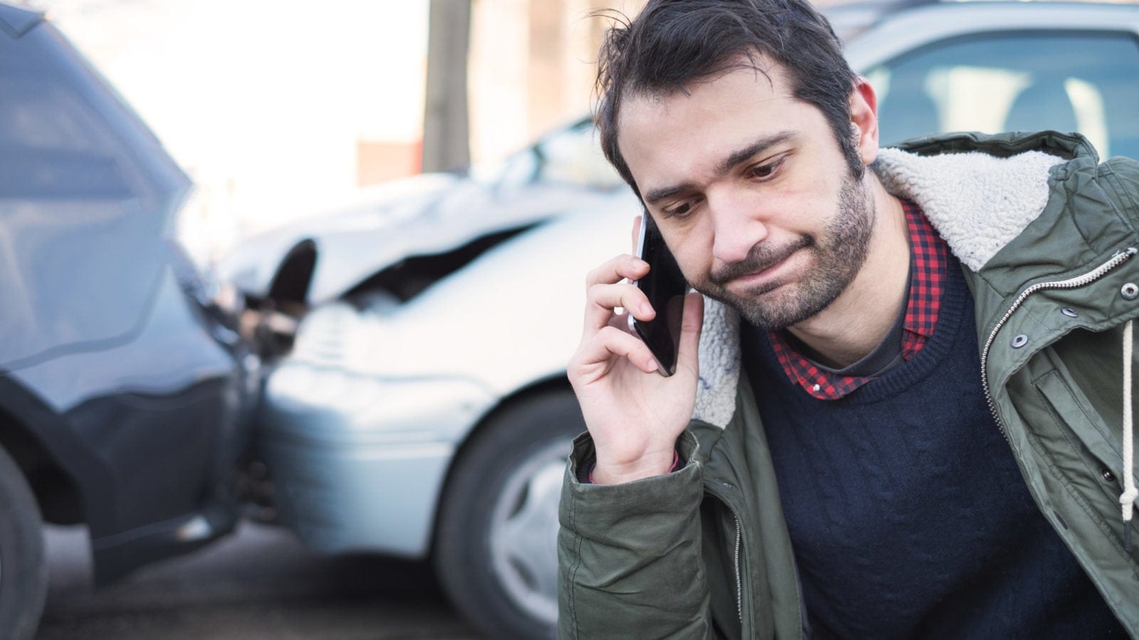 Male Driver Reporting A Car Accident Stock Photo