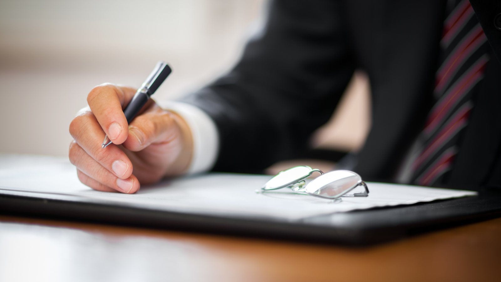Insurance Adjuster Signing A Document Stock Photo