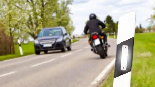 Motorcyclist Passing A Car On A Rural Road