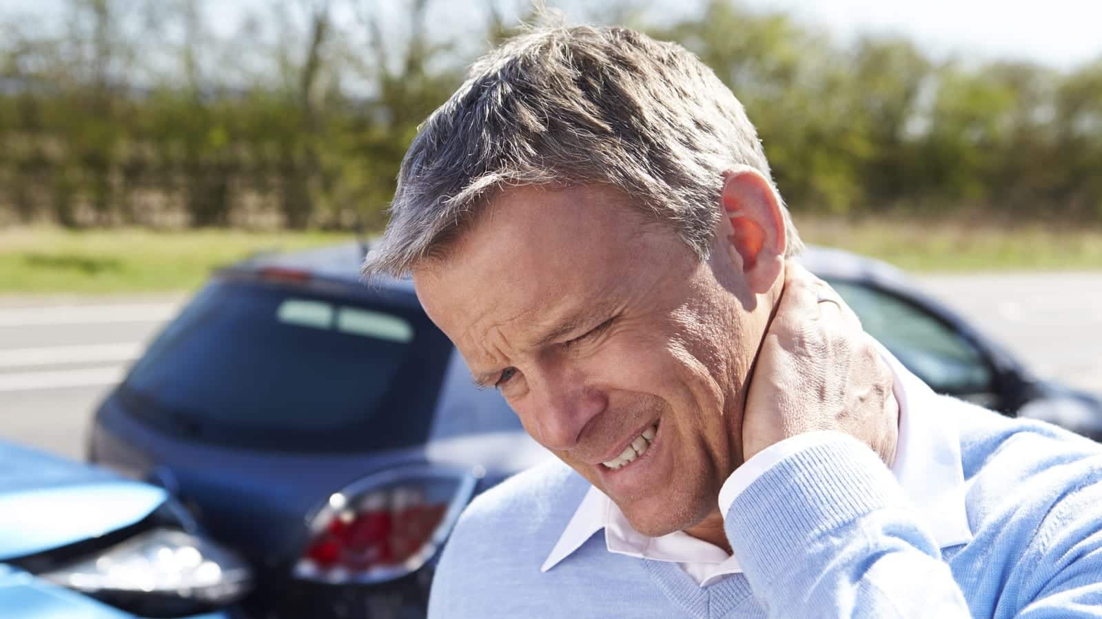 Older Man Experiencing Neck Pain After An Auto Accident Stock Photo