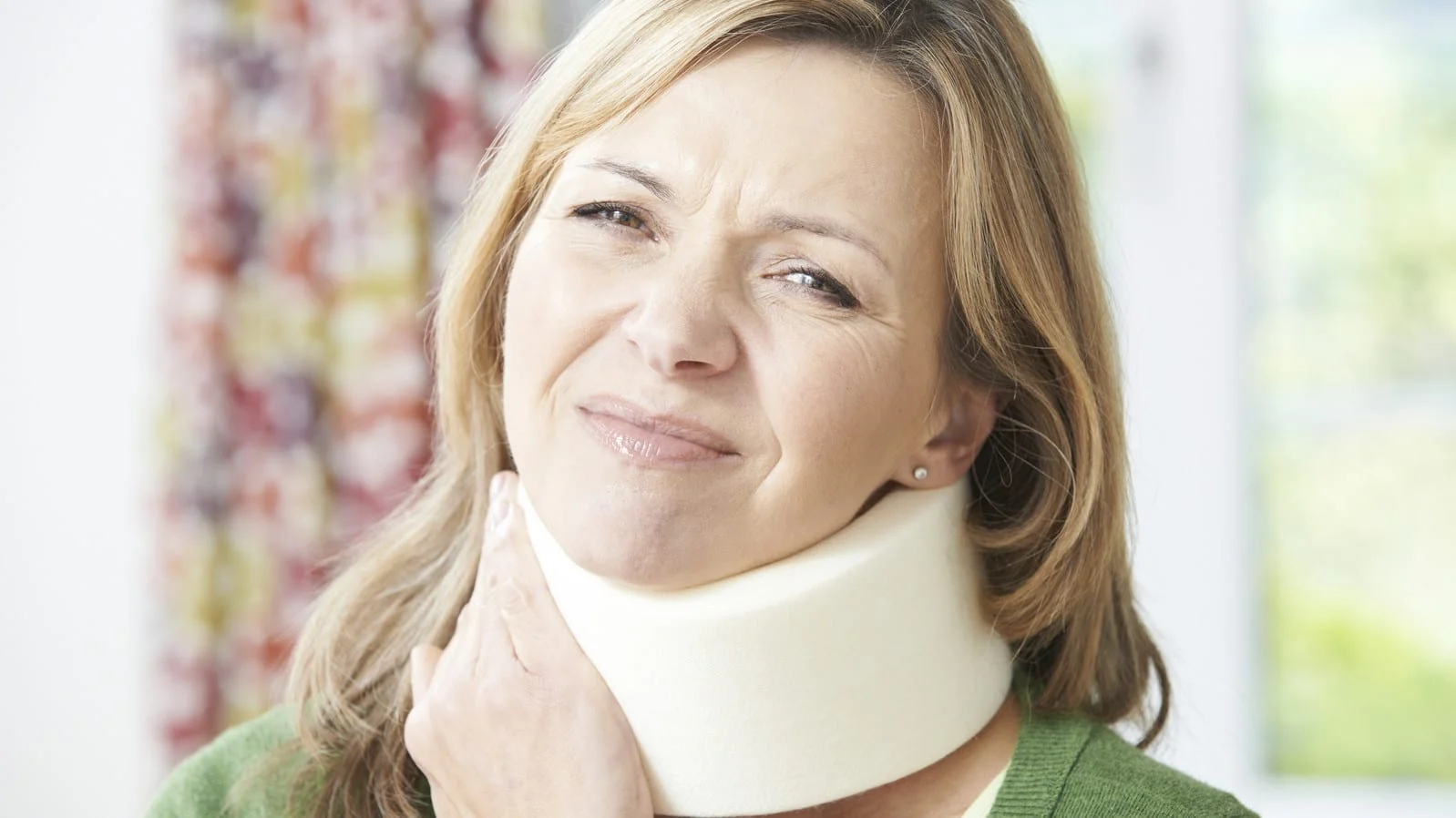 Mature Woman Experiencing Neck Pain Stock Photo
