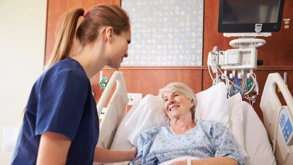 Female Nurse Consoling Elderly Female Patient