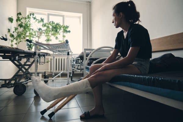 A woman sits at a hospital with a leg cast on after a slip and fall accident in Chattanooga.